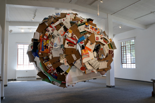 Cocoon art with used papers and cardboards and it is hanging in the air
